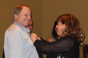Jan Nyquist is &quot;pinned&quot; by Rotary District 7010 Governor Lise Dutrasic.